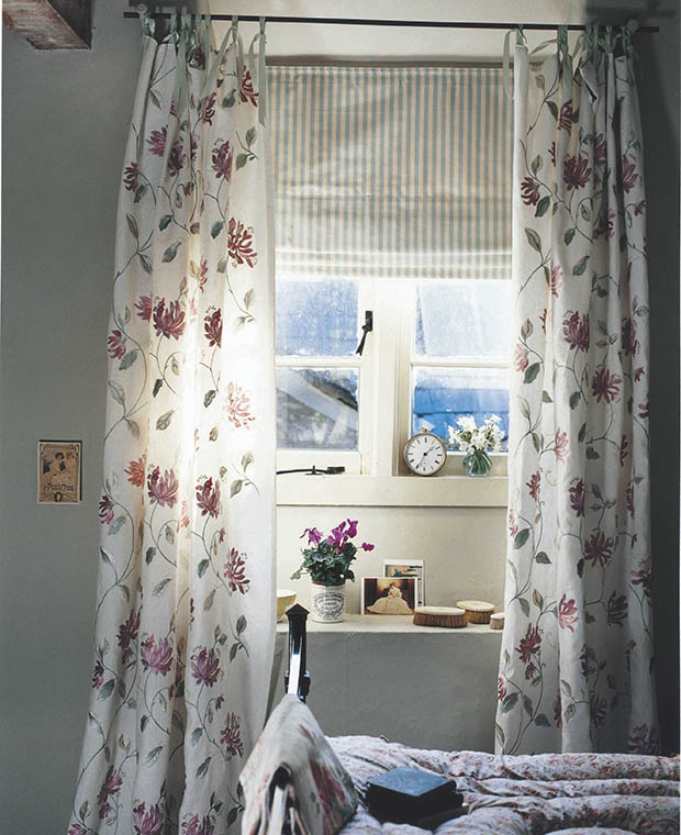 Curtain tied over window and blind to illustrate choosing blinds